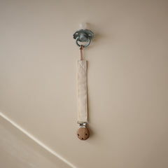 Mushie clip featuring faux wood silicone clasp for secure attachment