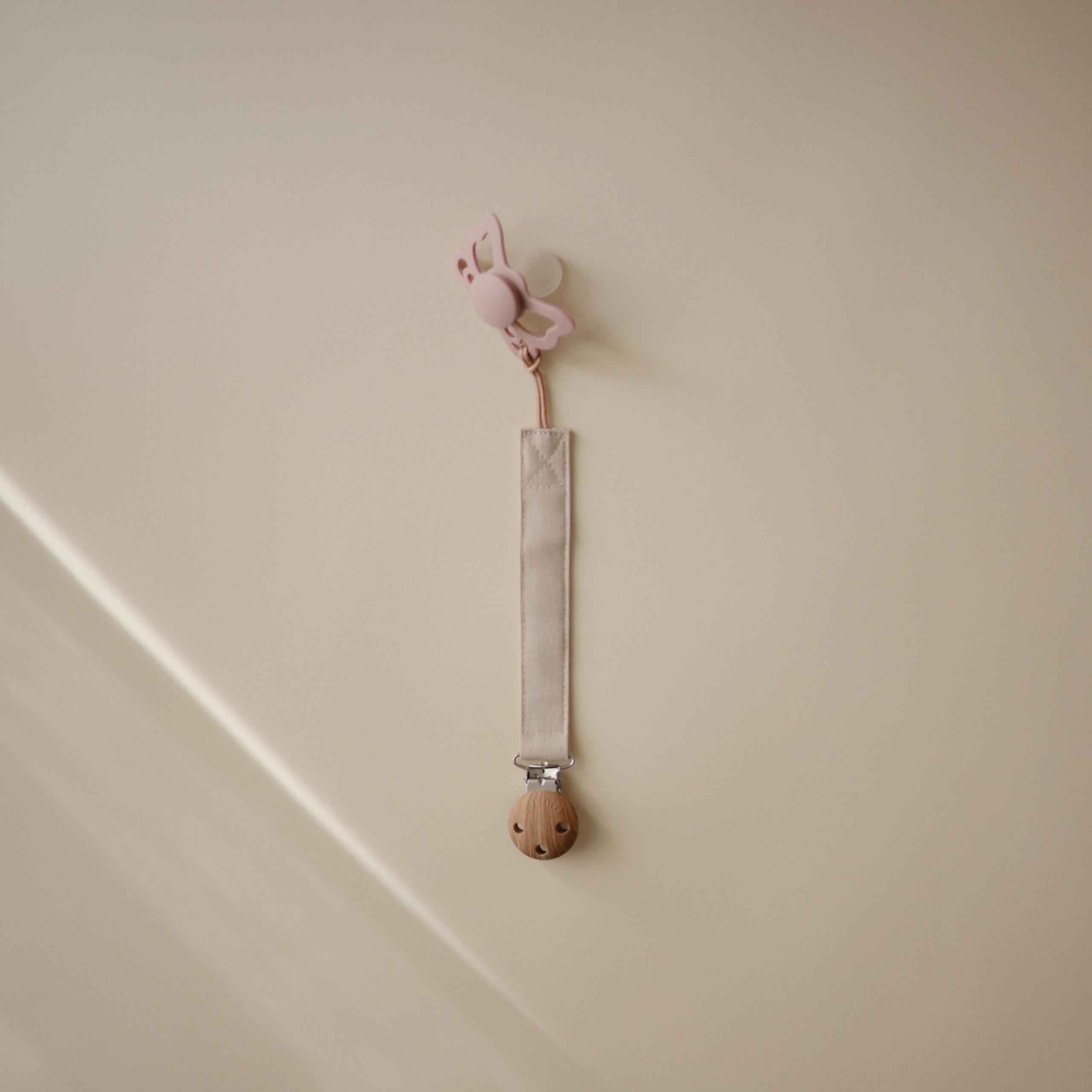 Mushie pacifier clip soft fabric closeup showing gentle texture