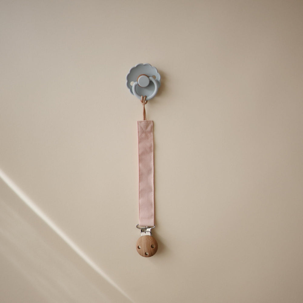 Mushie pacifier clip with soft fabric strap and durable clasp