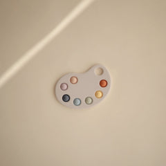 Mushie Paint Palette Press Toy soft colors emphasizing calm, engaging play.