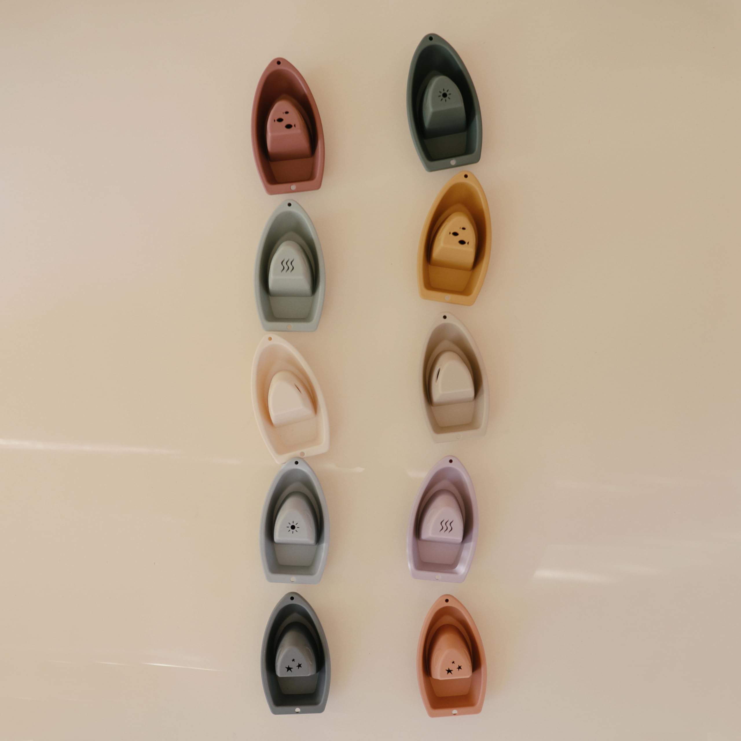Kids stack and connect boats, creating a flowing bath-time train.