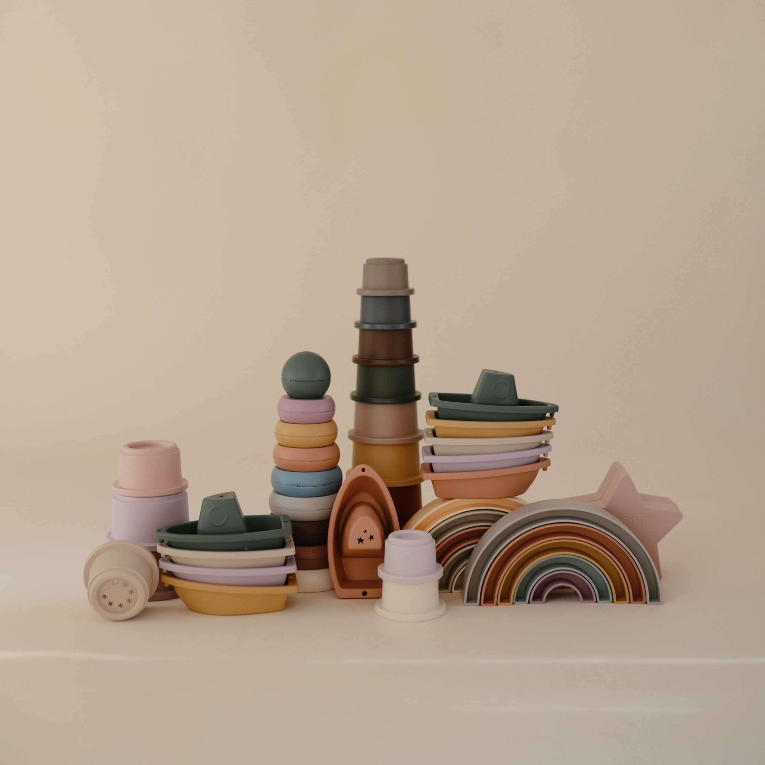 Five-piece set links into a graceful nautical train that floats in water.