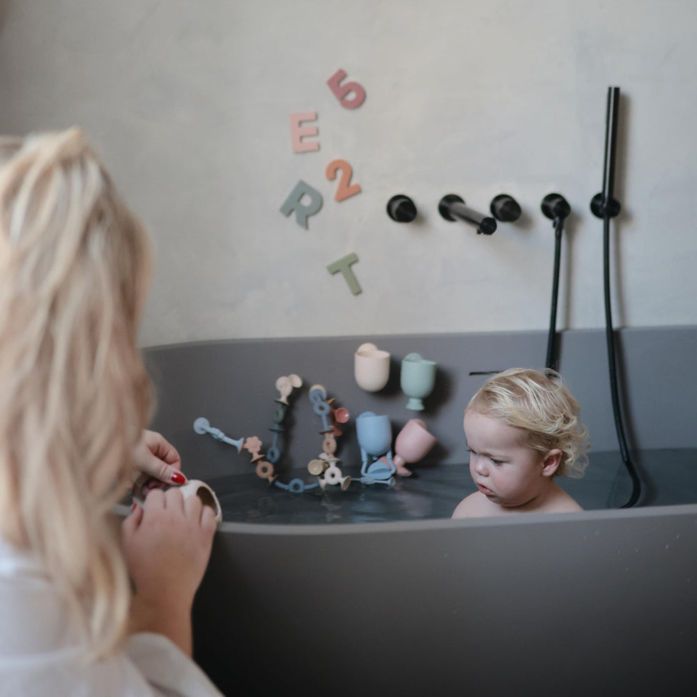 Mushie bath toy in muted colors supports calm, focused bath time.