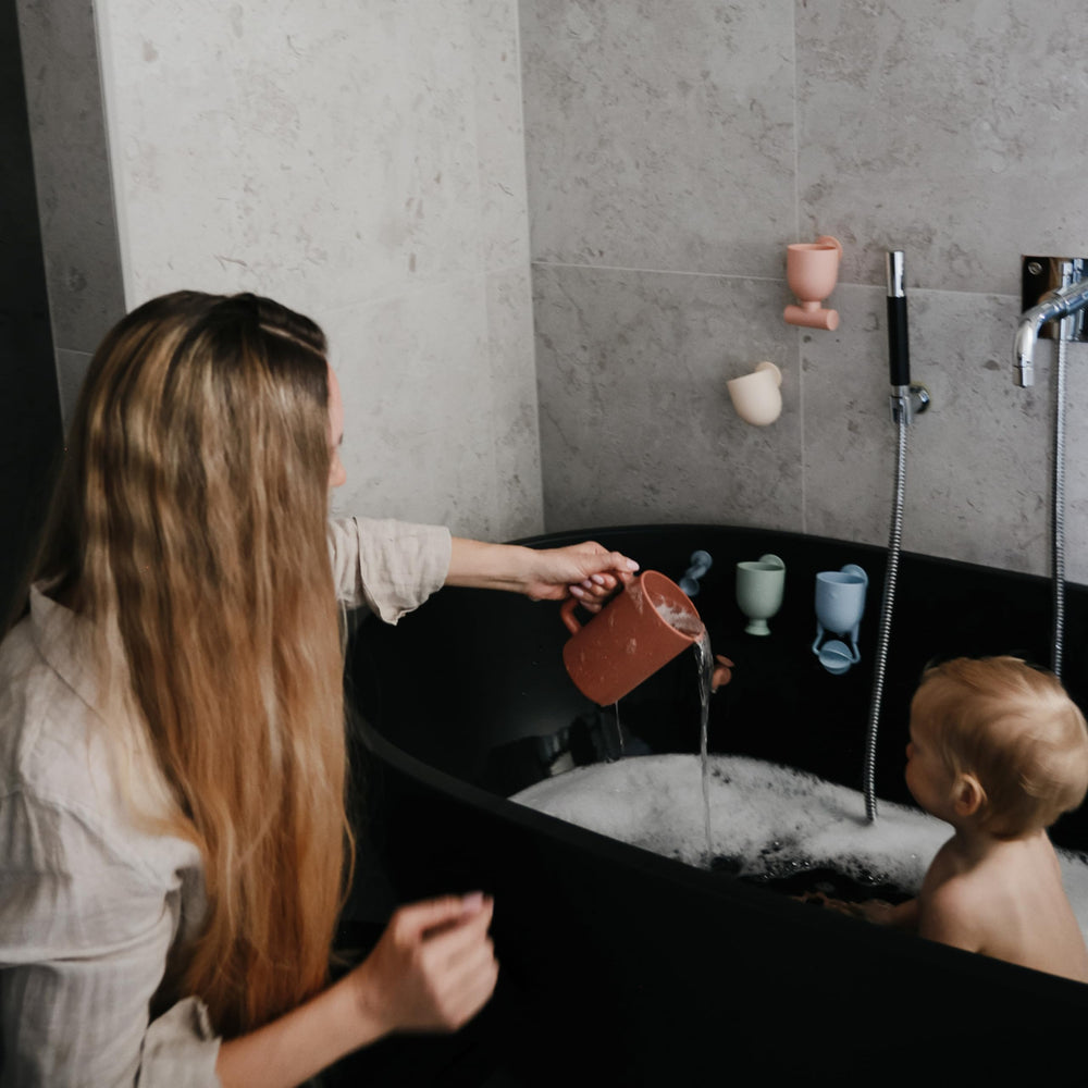 Mushie compact design fits small hands for easy grasp during bath play.