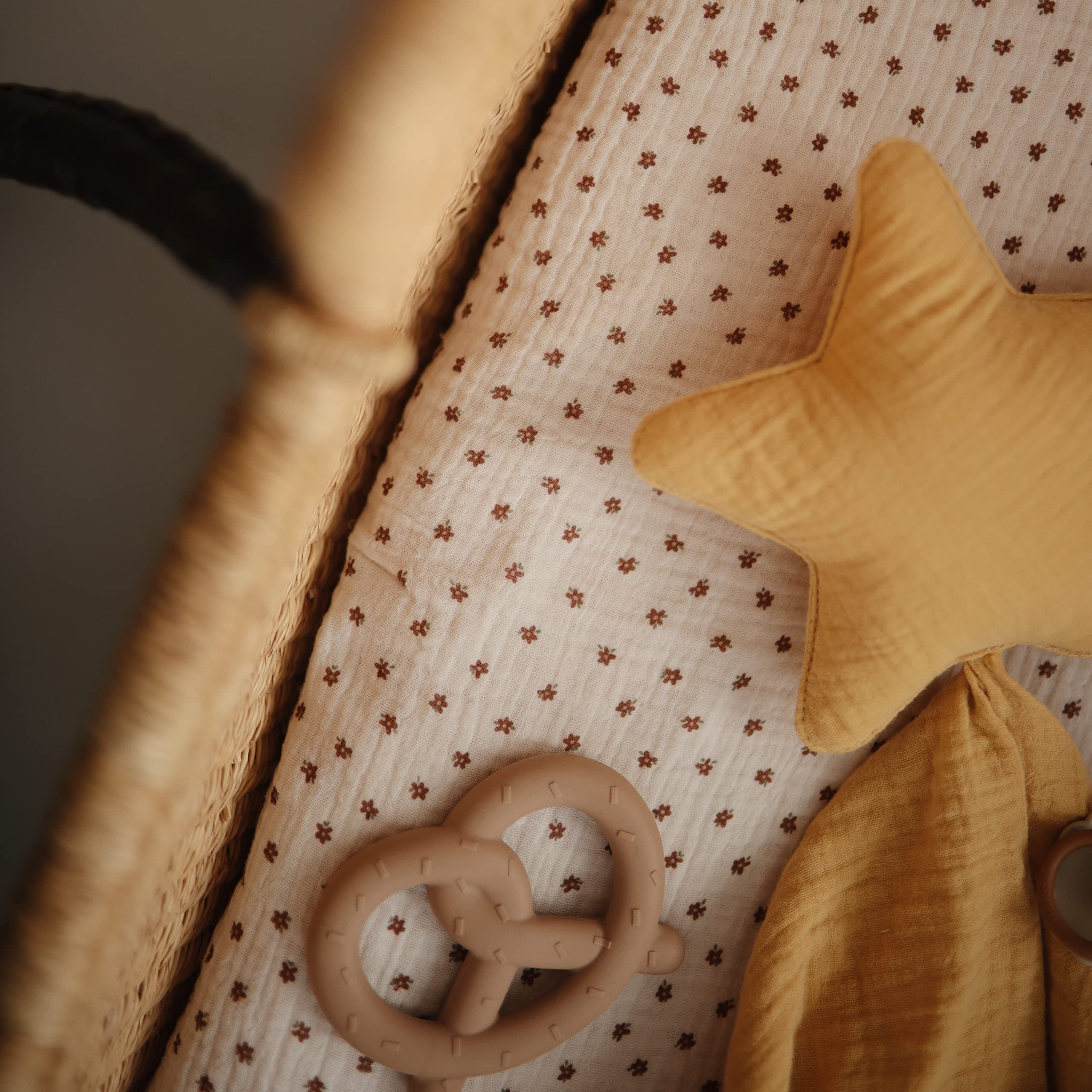 Mushie Pretzel teether being grasped by a baby demonstrates grip-friendly design