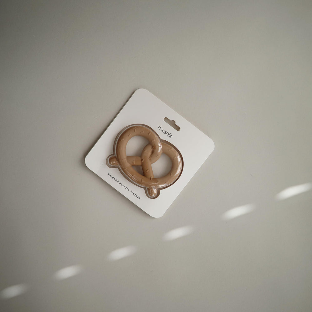 Mushie Pretzel teether in a nursery scene showcases safe, accessible design