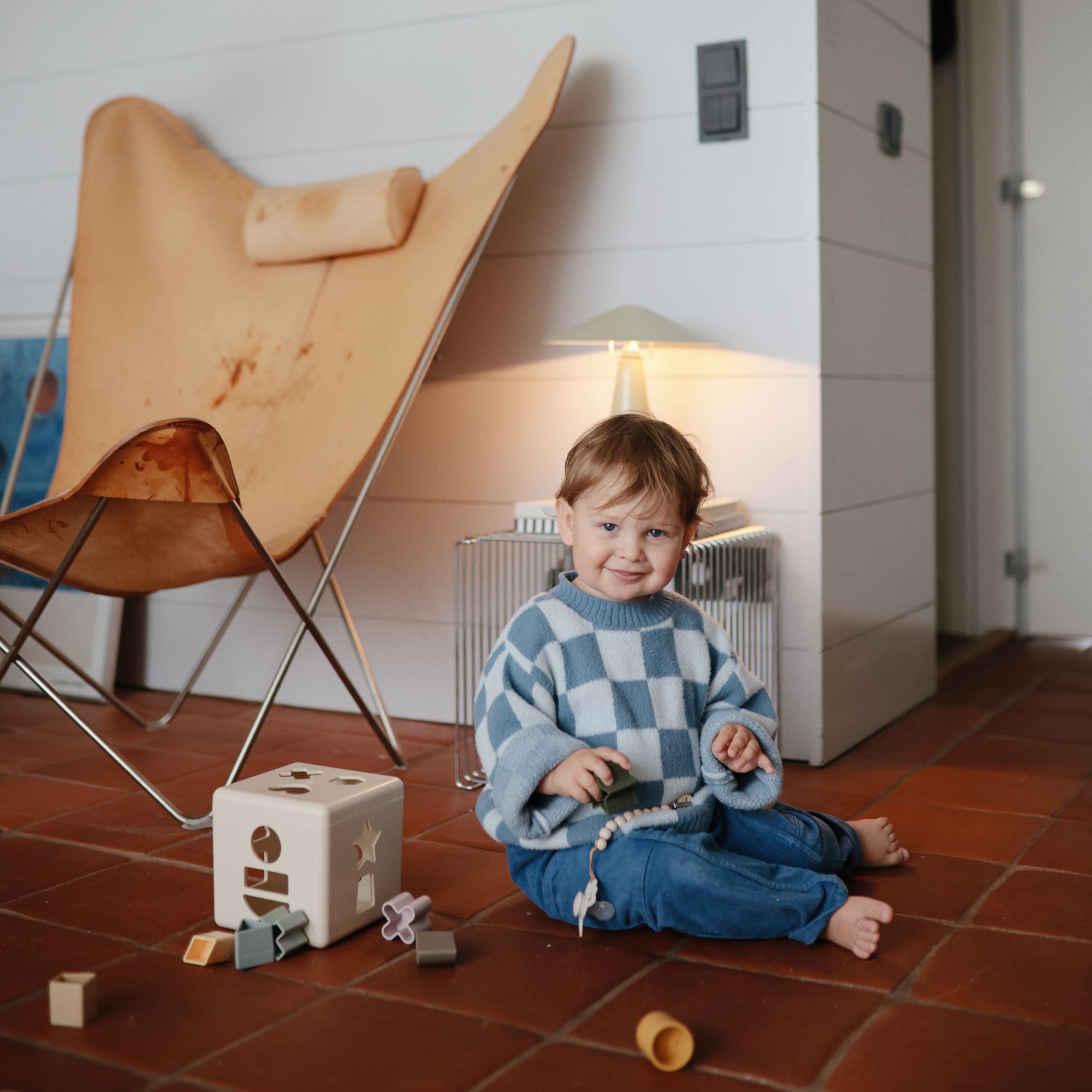 Mushie Shape Sorting Box Original toddler play promotes hand-eye coordination.