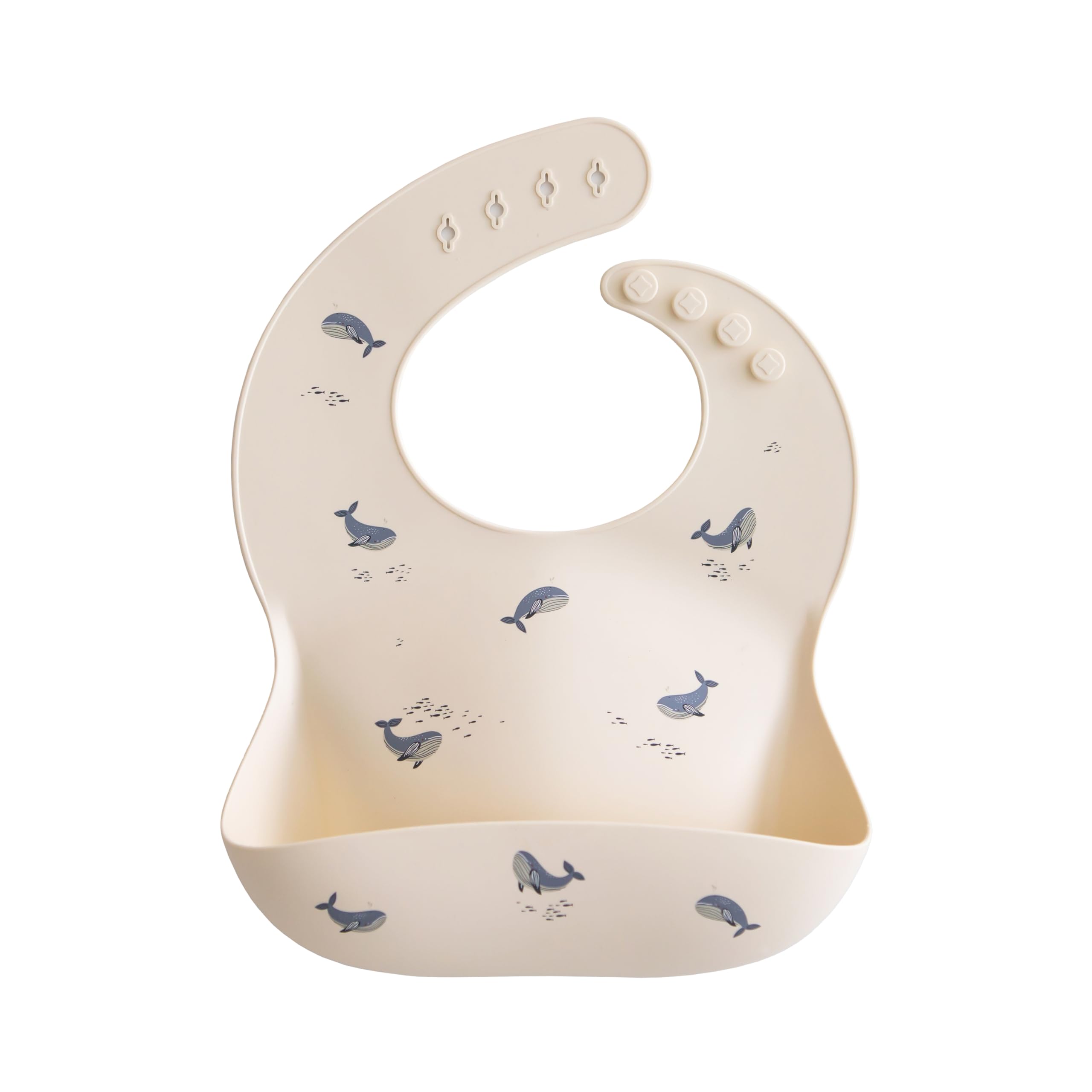 Mushie silicone baby bib with adjustable fit in whales pattern for mess-free mealtimes.