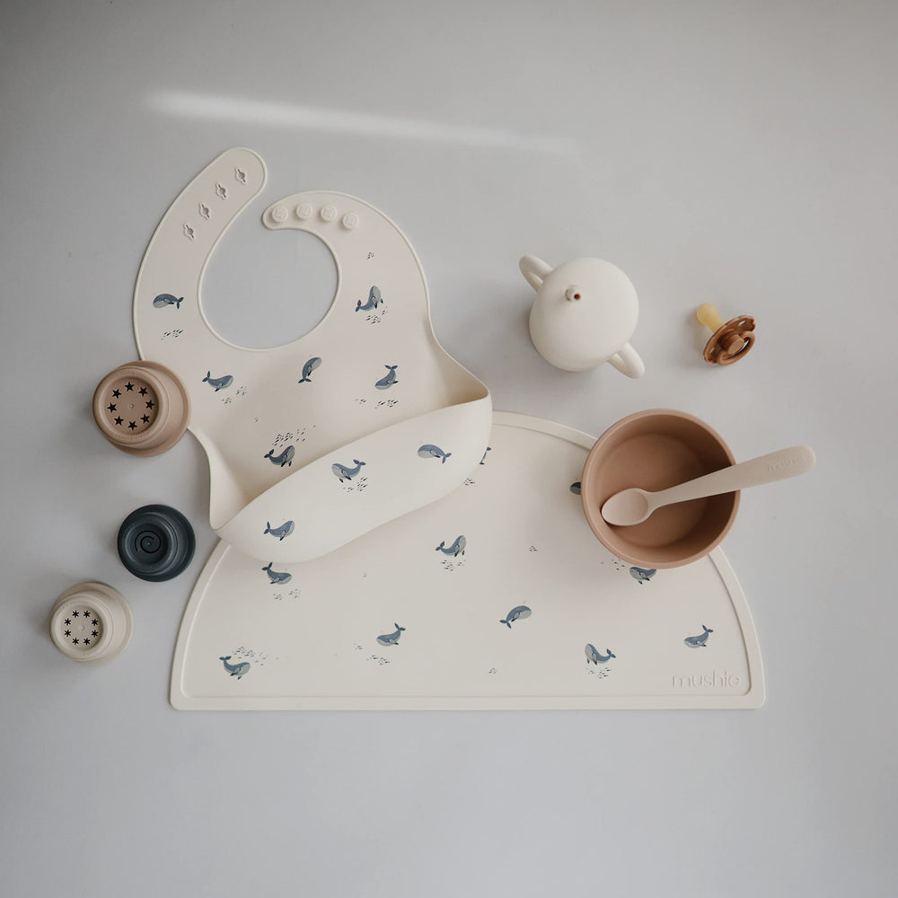 Mushie silicone bib waterproof design keeps clothes dry during meals.