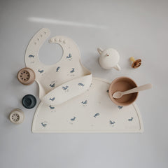 Mushie silicone bib waterproof design keeps clothes dry during meals.