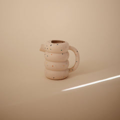 Mushie silicone watering can on a kitchen rack after top-shelf dishwasher safe cleaning.