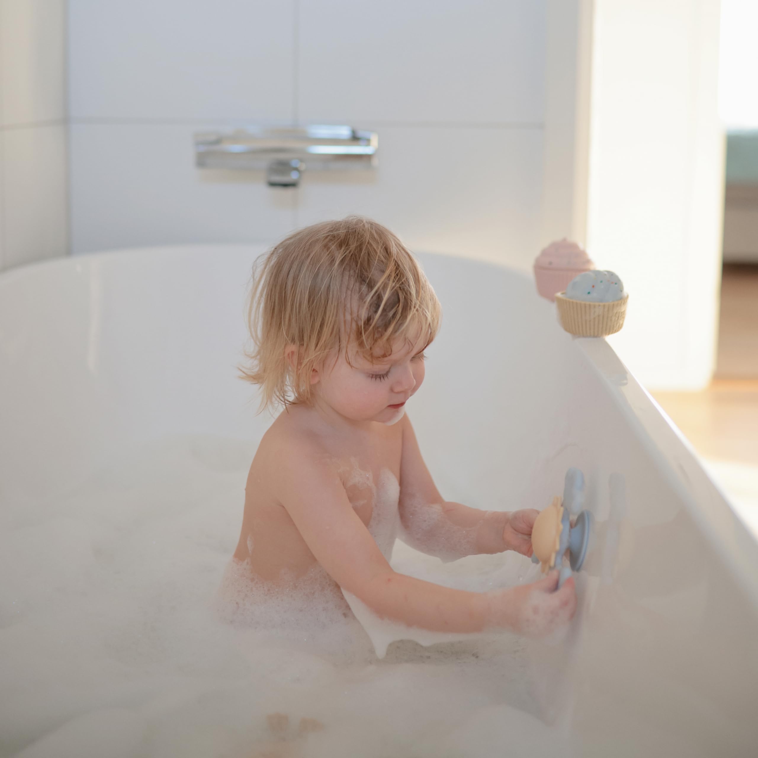 Mushie Sunshine Suction Spinner Toy adheres to cabinet doors for portable fiddle-and-spin moments.