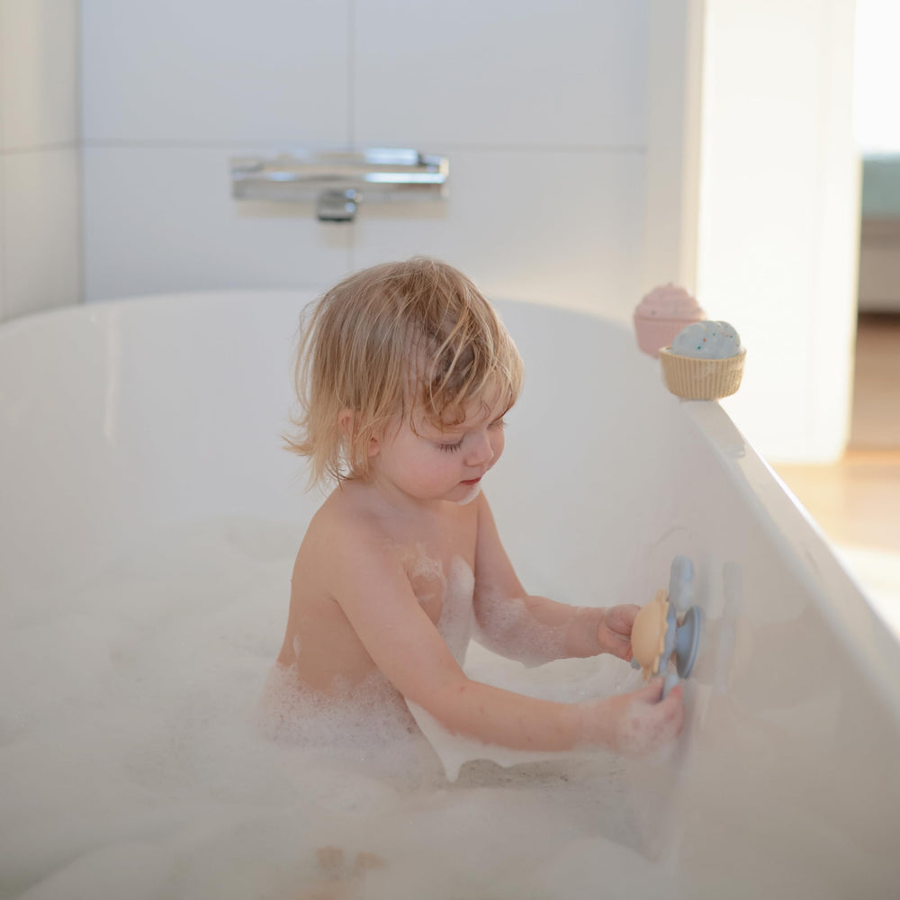 Mushie Sunshine Suction Spinner Toy adheres to cabinet doors for portable fiddle-and-spin moments.