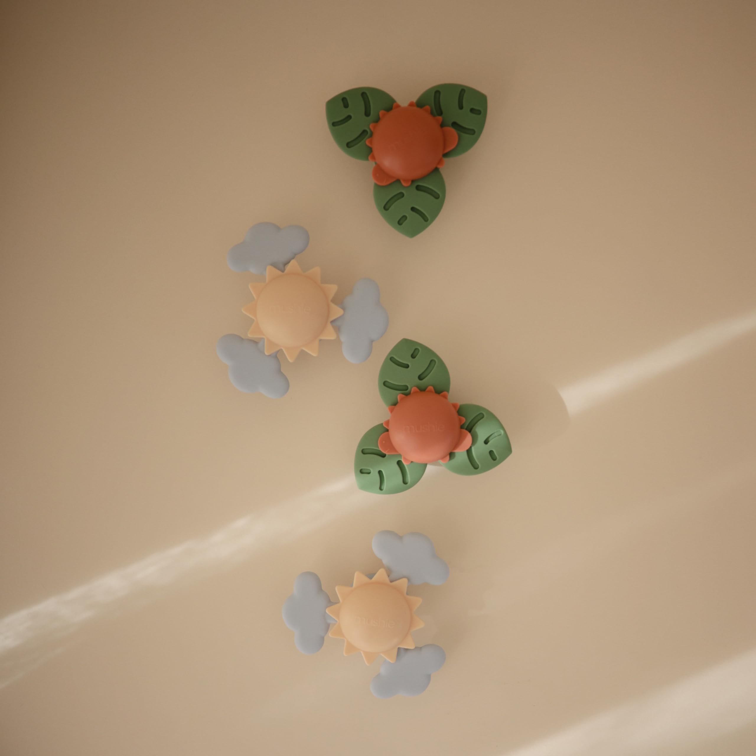 Mushie Sunshine Suction Spinner Toy features strong suction for stable independent play on flat surfaces.