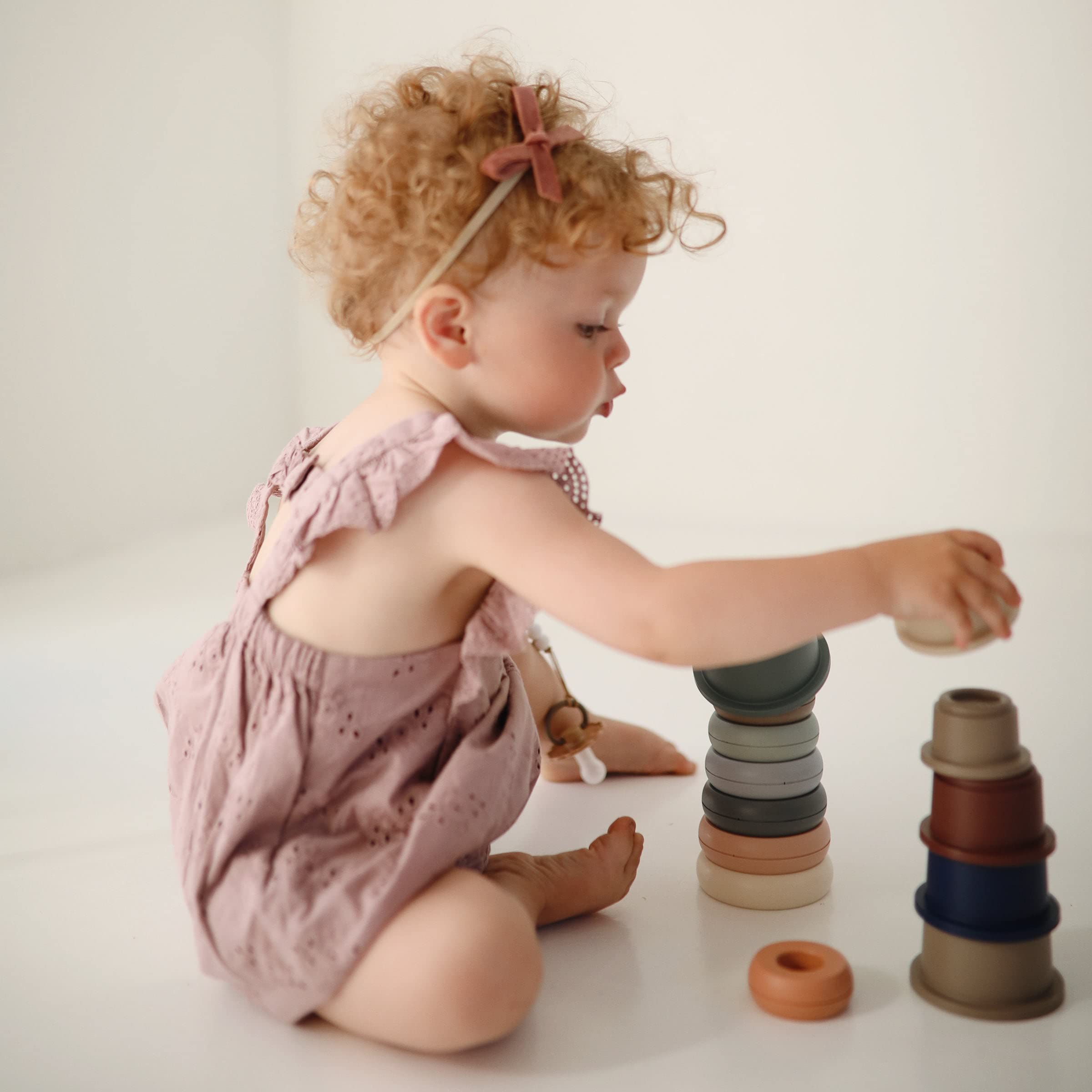Mushie rounded shapes image emphasizes tactile stacks and sensory exploration.
