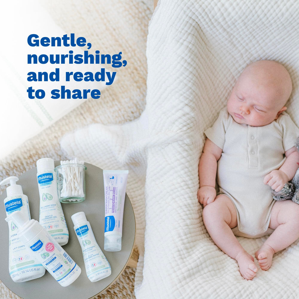 Parent holds Mustela baby skin care essentials for a routine.