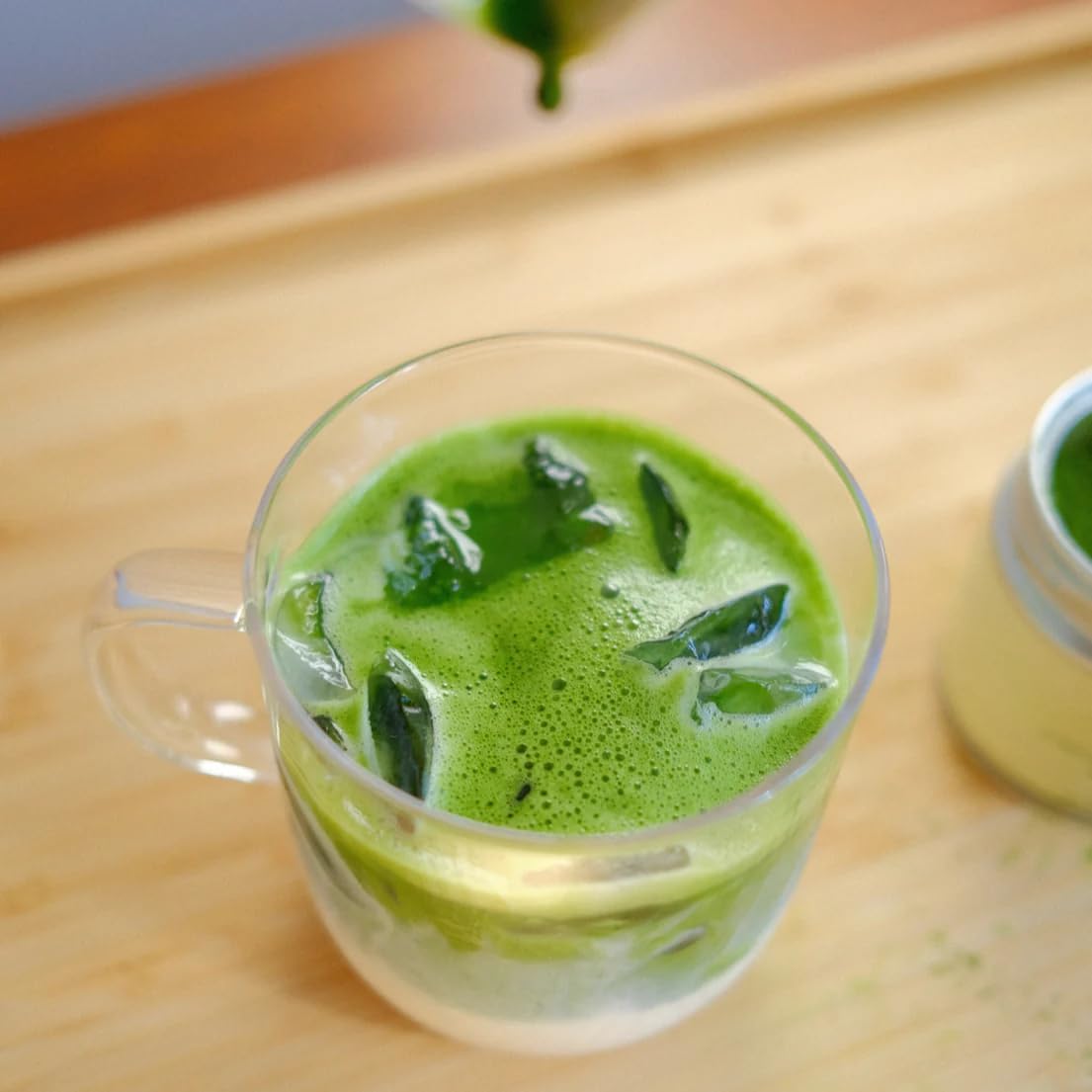 Nami Matcha Okumidori packaging display emphasizes organic shade-grown harvest and sustainability.