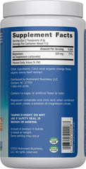 Natural Vitality CALM powder dissolving in water to create a soothing orange drink.