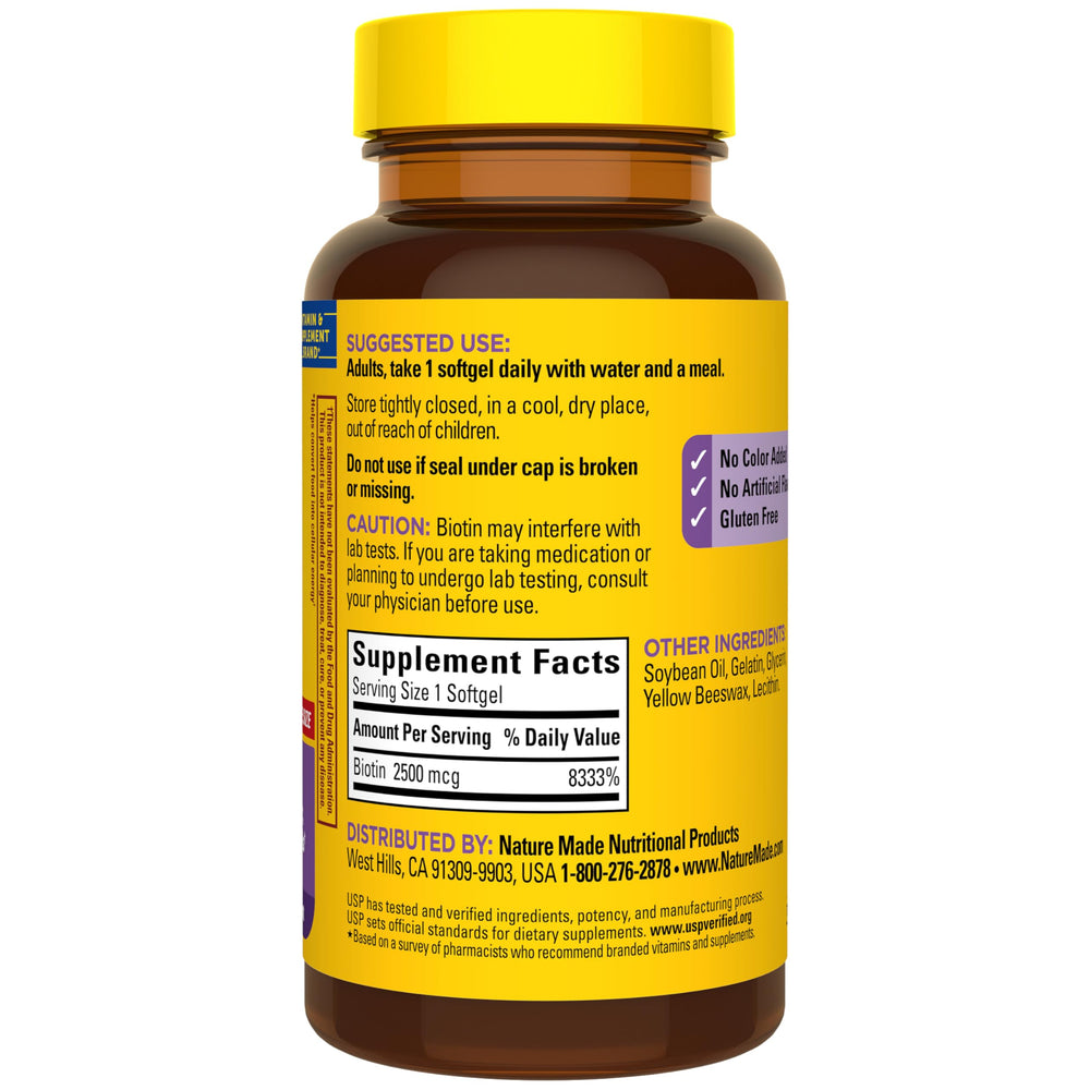 Person taking Nature Made Biotin softgel with water as part of daily routine.