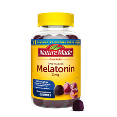 Nature Made Time Release Melatonin bottle on a nightstand for gradual sleep support