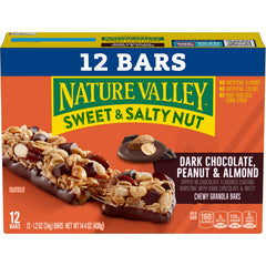 Hand holding a Nature Valley dark chocolate peanut almond bar for on-the-go energy.