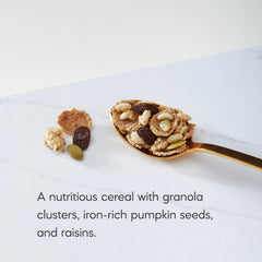 Nature's Path Flax Plus Pumpkin Raisin Crunch granola clusters on a spoon deliver a satisfying crunch.