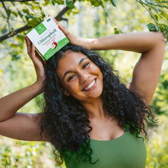 Glass of water mixed with Nature's Sunshine chlorophyll showing appealing green color and ready-to-drink convenience