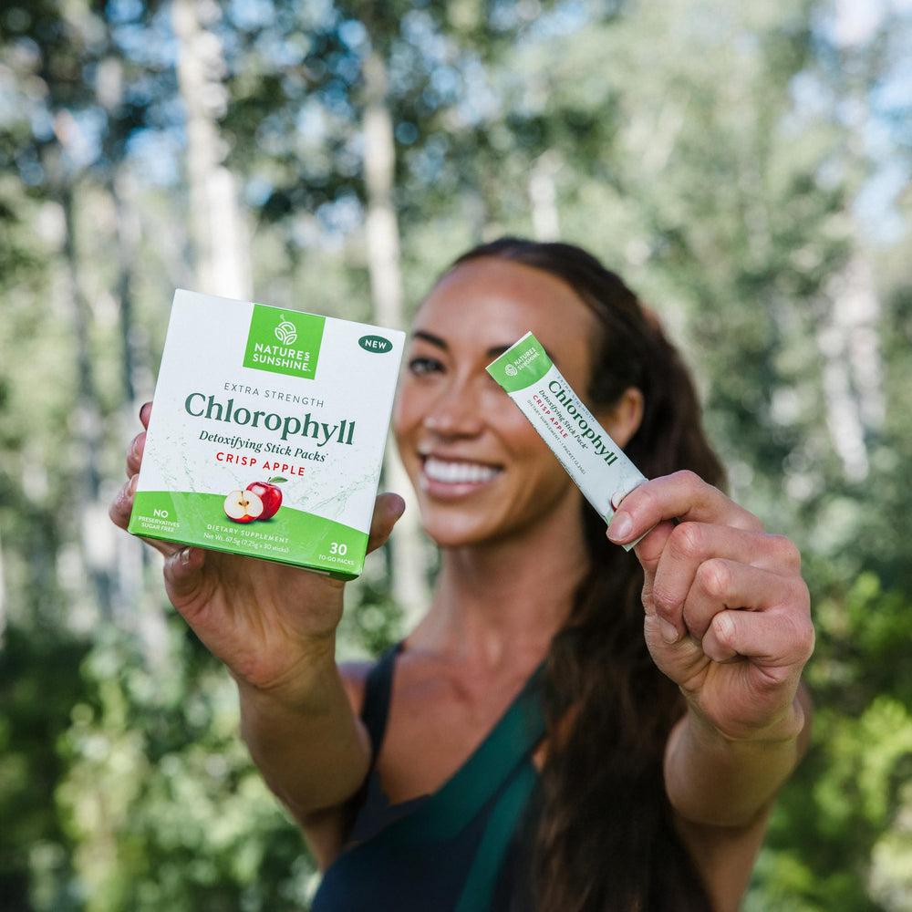 Nature's Sunshine stick pack placed beside a fresh apple to emphasize crisp apple flavor and natural taste