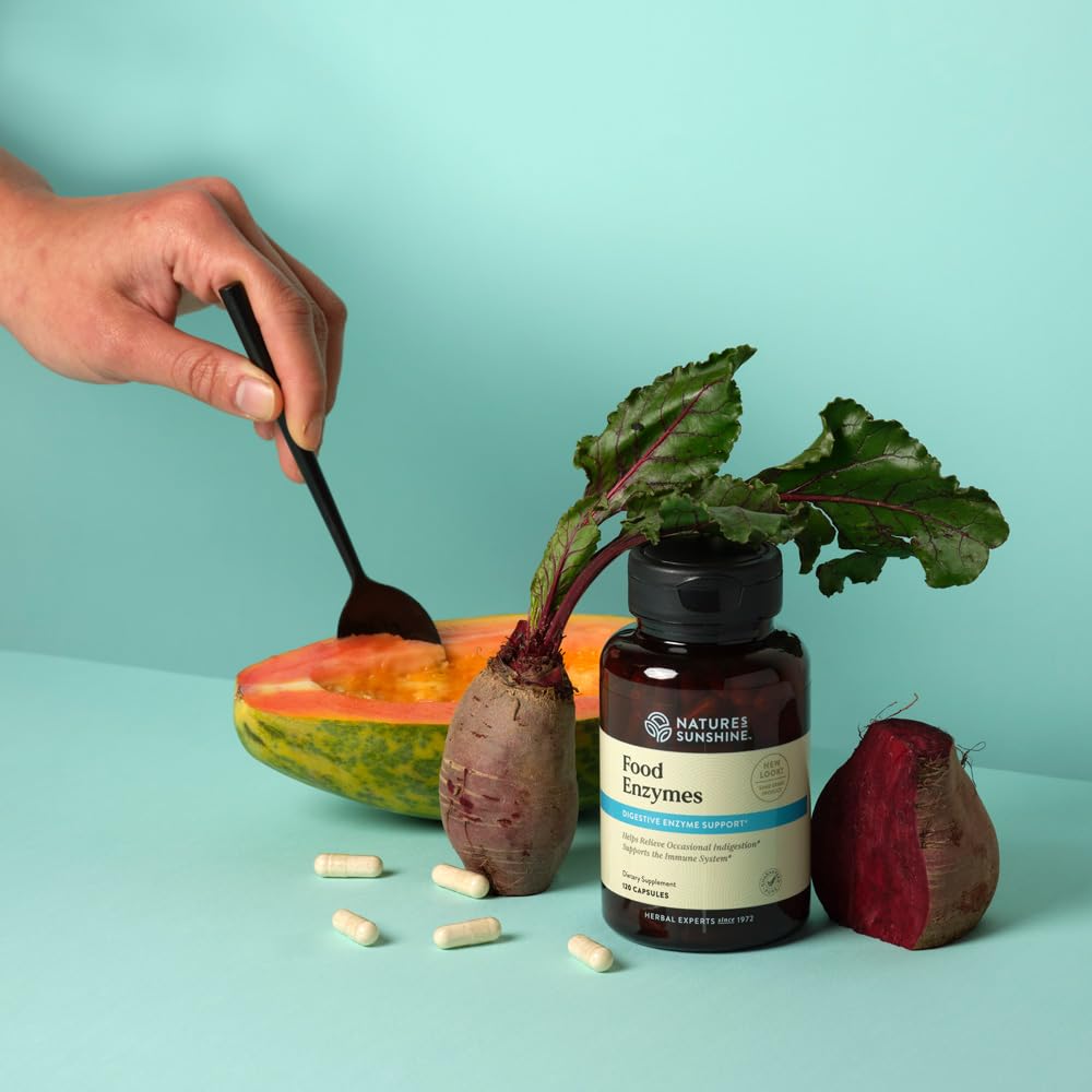 Nature's Sunshine Food Enzymes capsules in hand show convenient post-meal support.