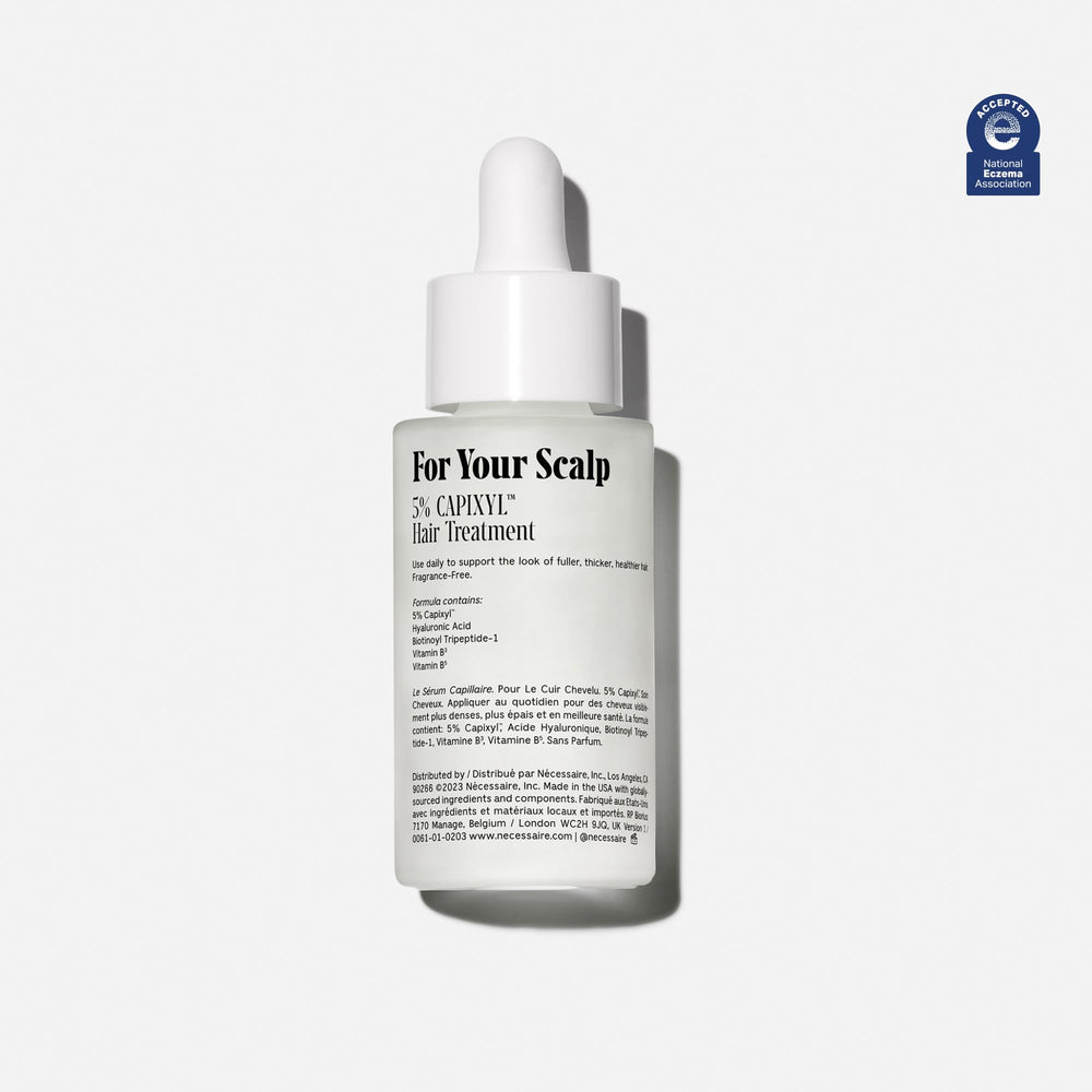 Nécessaire Scalp Serum pipette demonstrates precise dosing for targeted scalp application.