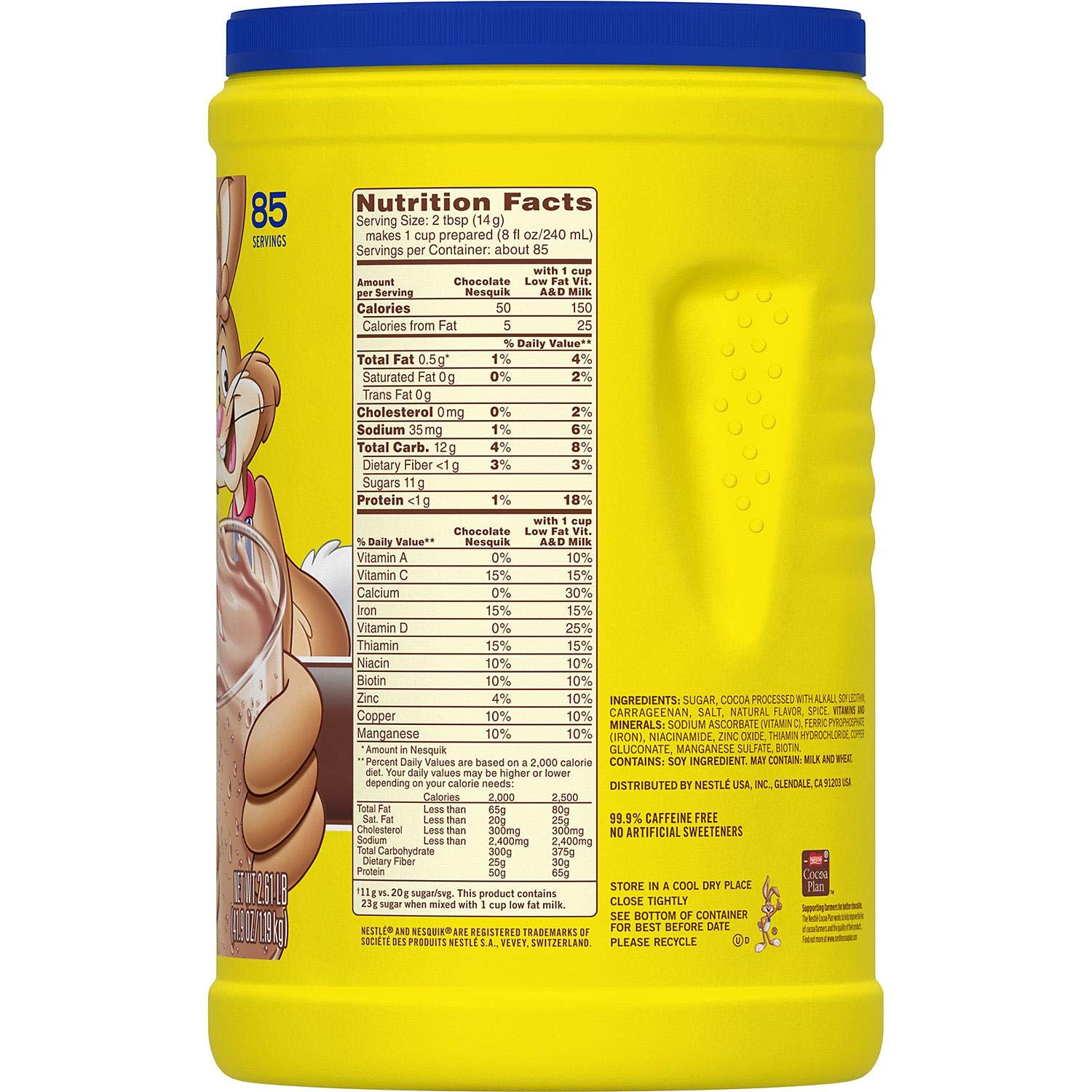 Nesquik powder being stirred into a glass for a flavorful shake.