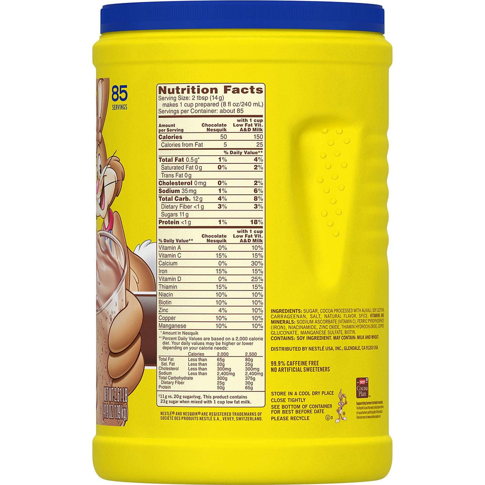 Nesquik powder being stirred into a glass for a flavorful shake.