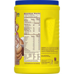 Nesquik powder being stirred into a glass for a flavorful shake.