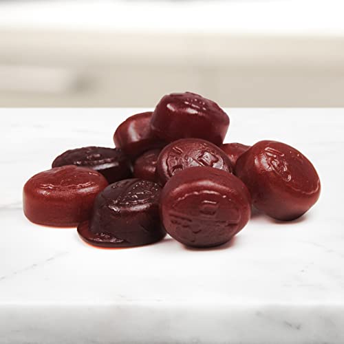 Fresh strawberries next to NEURIVA strawberry gummies.