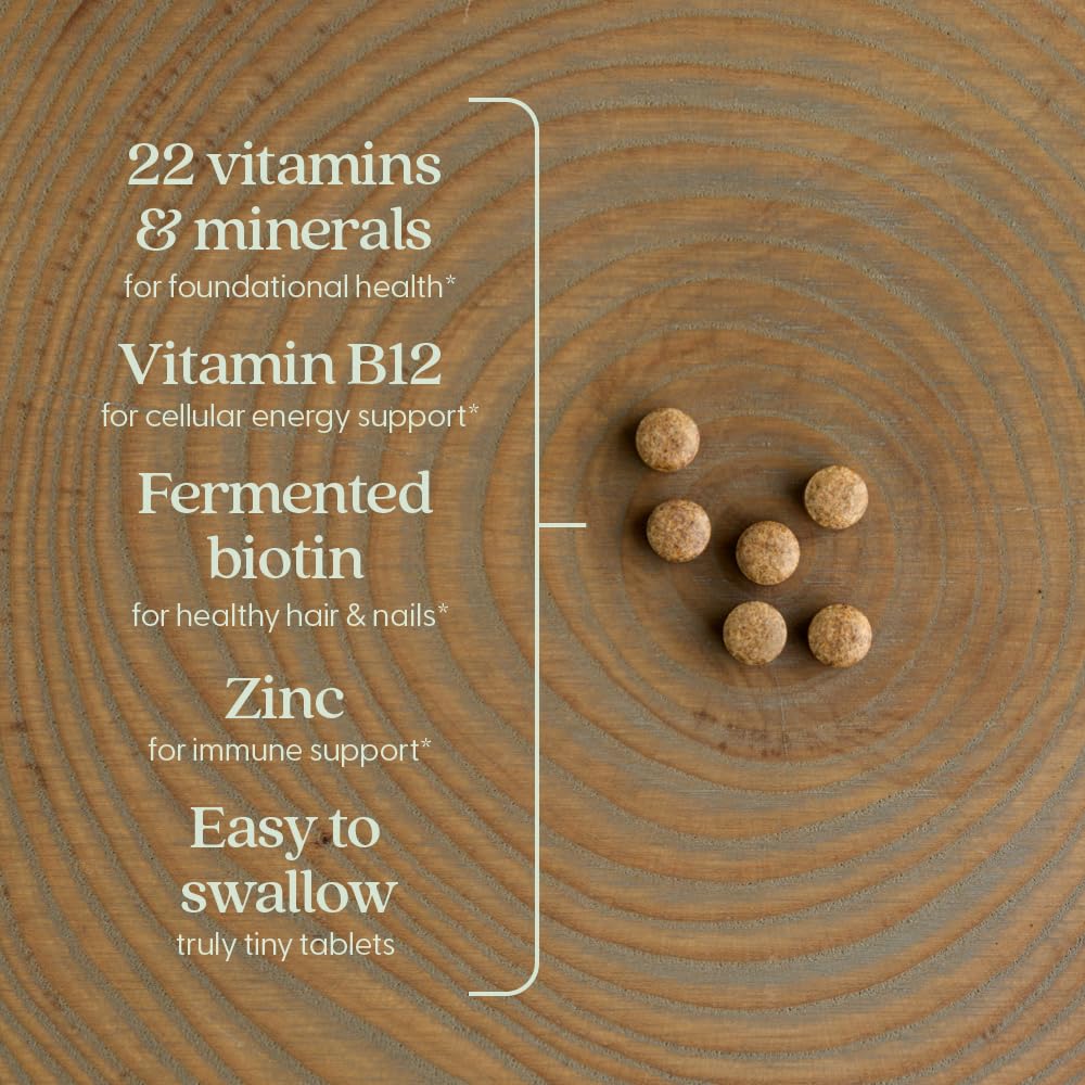 New Chapter Tiny Tabs tablets in hand illustrating portable daily supplement on the go