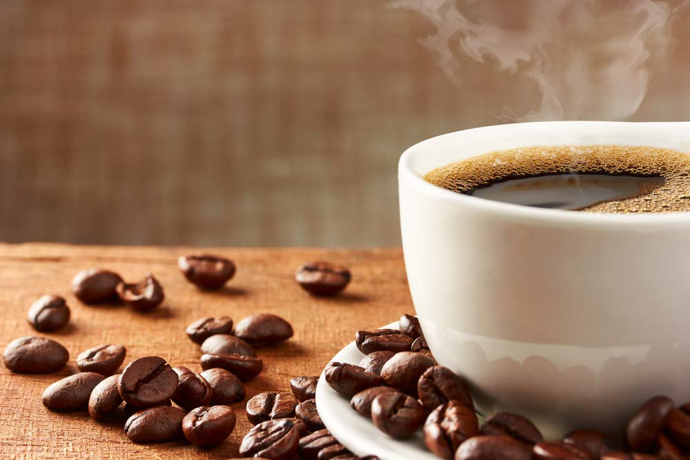 New England Coffee Hazelnut Creme Decaf label closeup highlighting sustainability and roast.