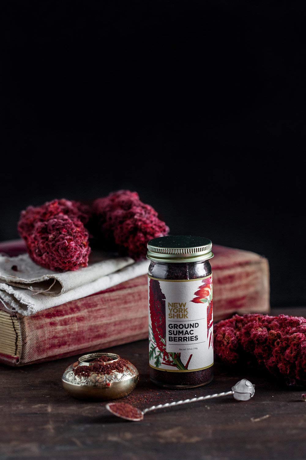New York Shuk Ground Sumac Berries spice blend pouring, adds tang to grains and marinades.