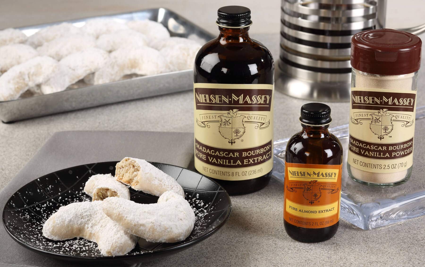 Nielsen-Massey Pure Almond Extract in a mixing bowl ready for batter.