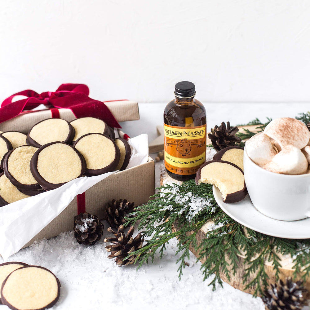 Nielsen-Massey Pure Almond Extract on a spice shelf signaling all natural quality.