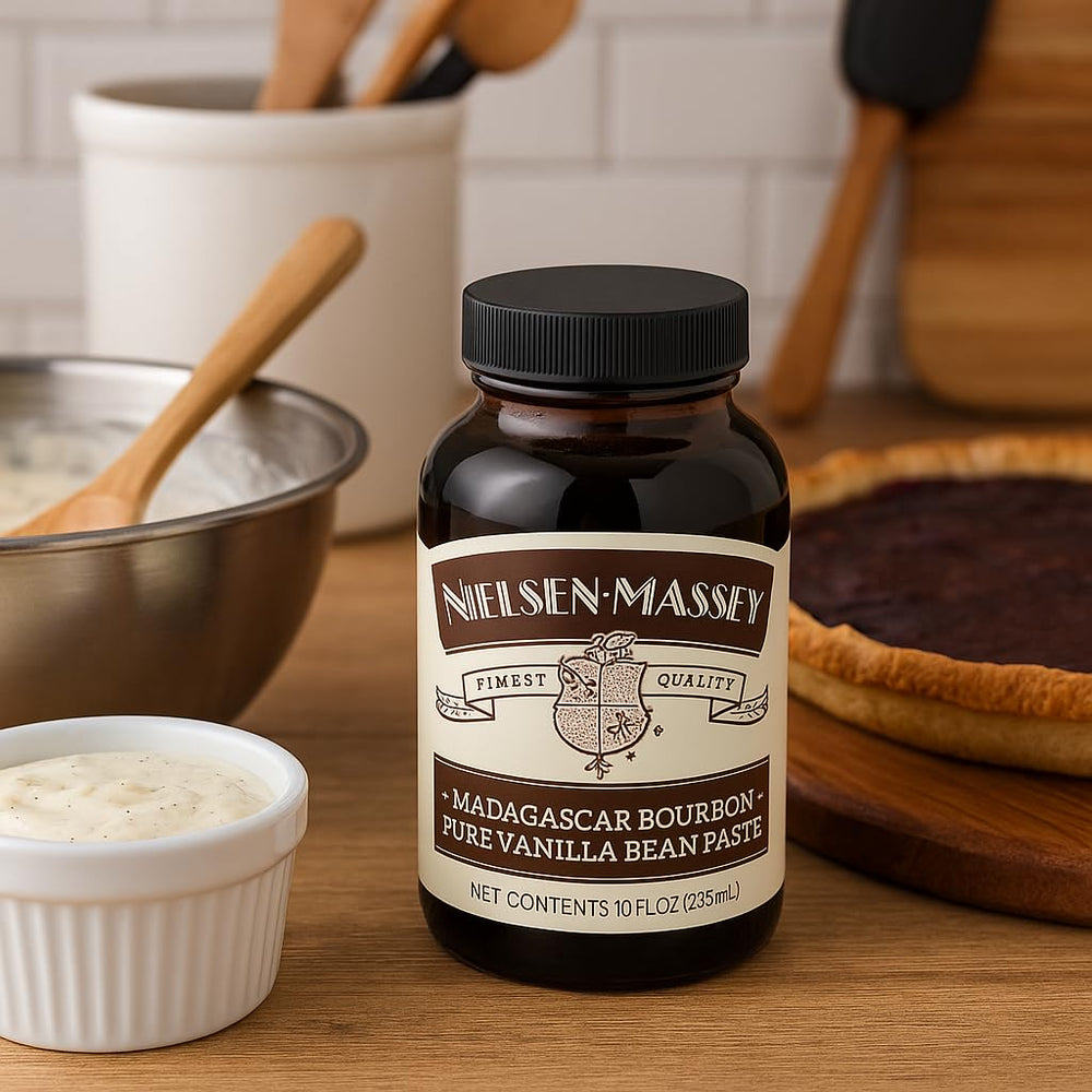 Nielsen-Massey Vanilla Bean Paste being poured into batter for rich aroma.