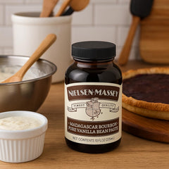 Nielsen-Massey Vanilla Bean Paste being poured into batter for rich aroma.