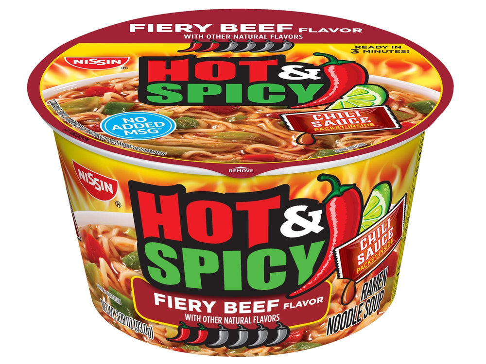 Nissin Hot and Spicy ramen served with chopsticks and toppings.
