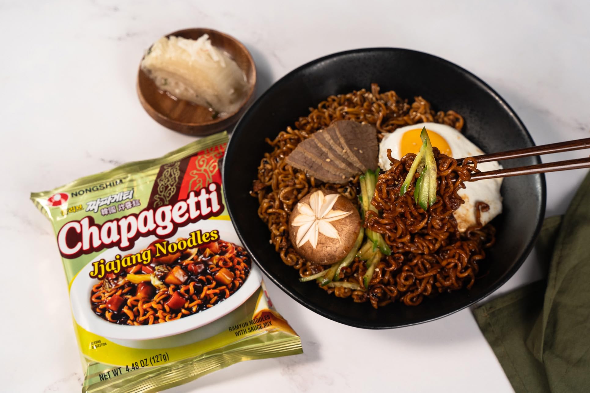 Nongshim Chapagetti ingredients highlight carrots, onions, and beans.