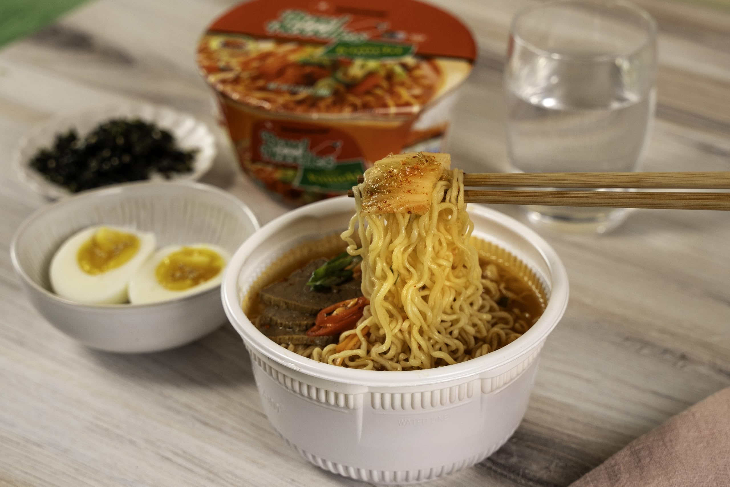 Nongshim Kimchi Bowl ingredients with vegetables and sauce pack