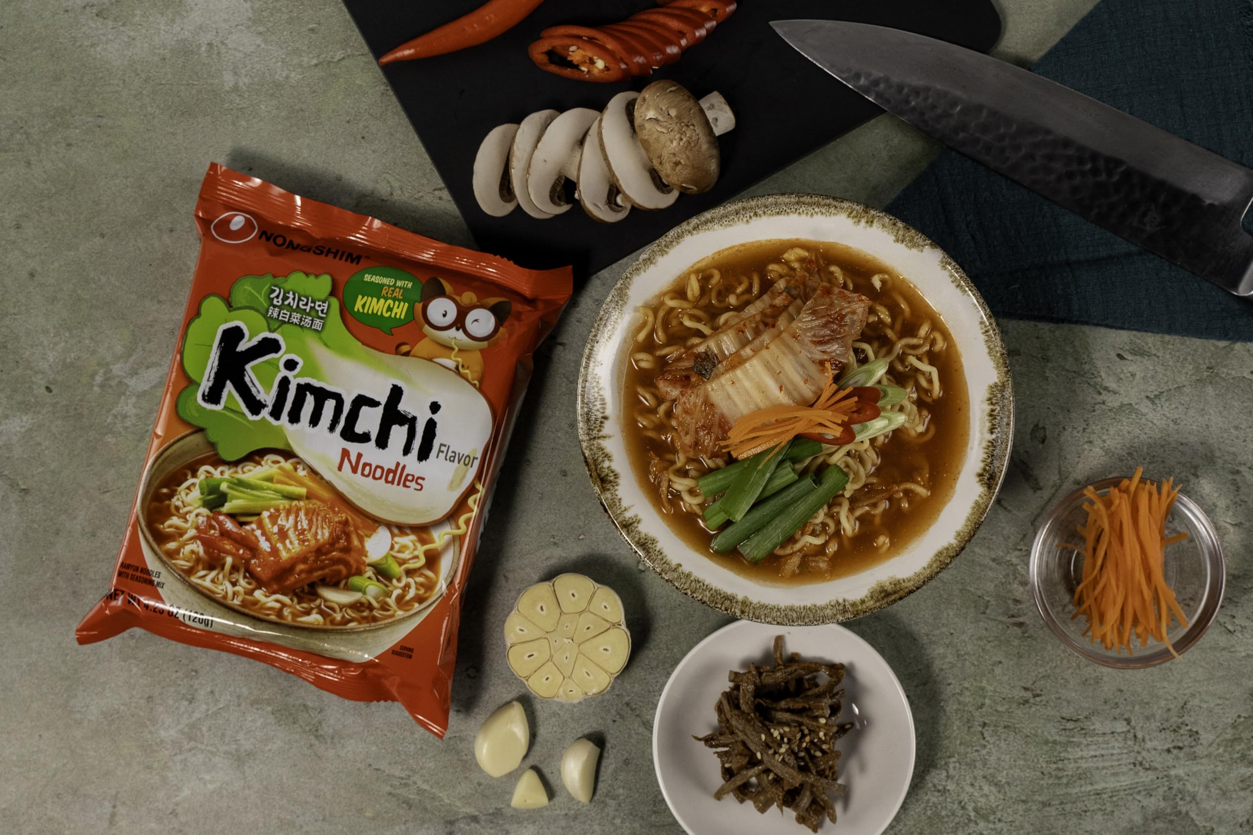 Nongshim Kimchi Ramen kimchi-flakes close-up emphasizes tangy aroma and crunch