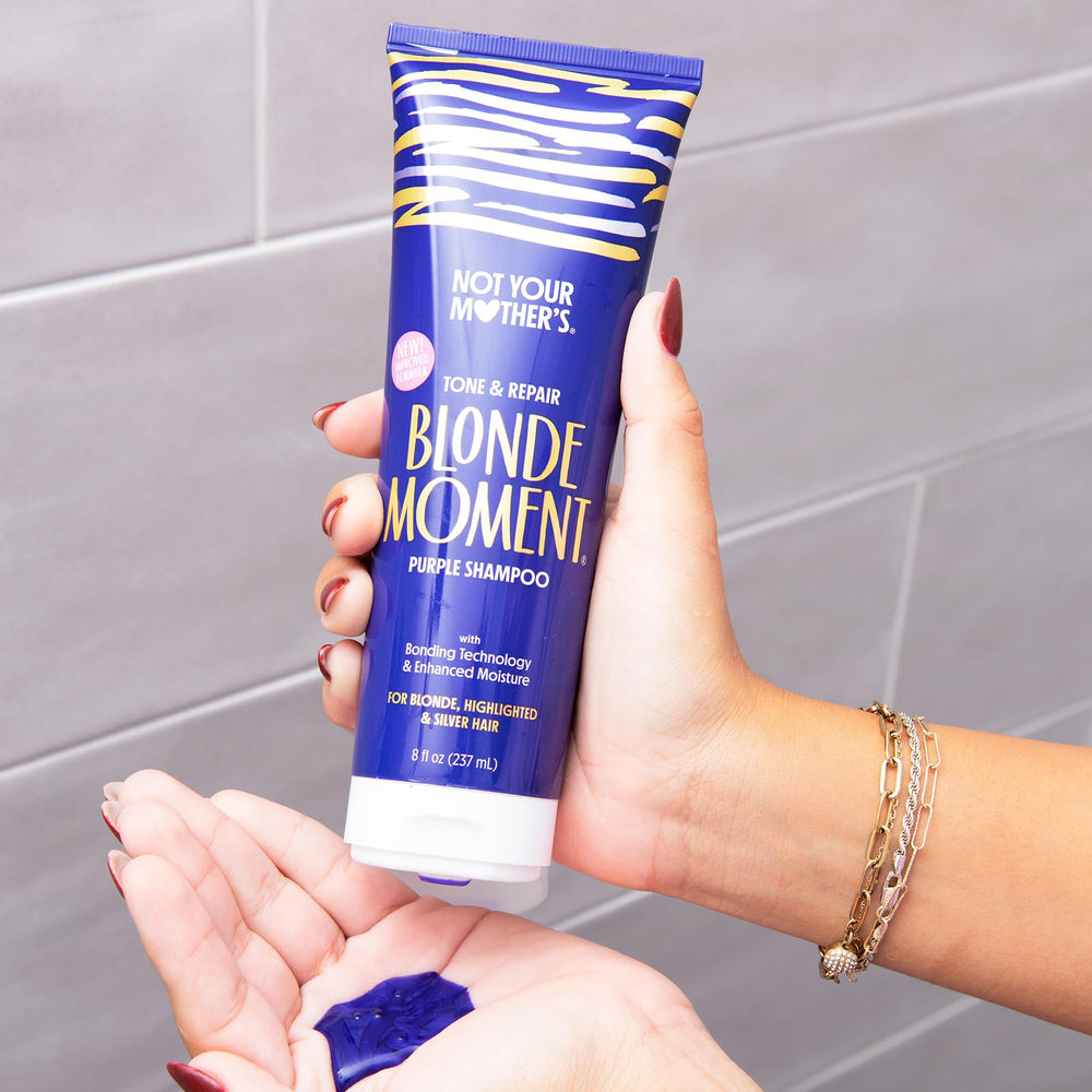 Not Your Mother's Blonde Moment Purple Conditioner bottle promoting color retention on lightened hair.