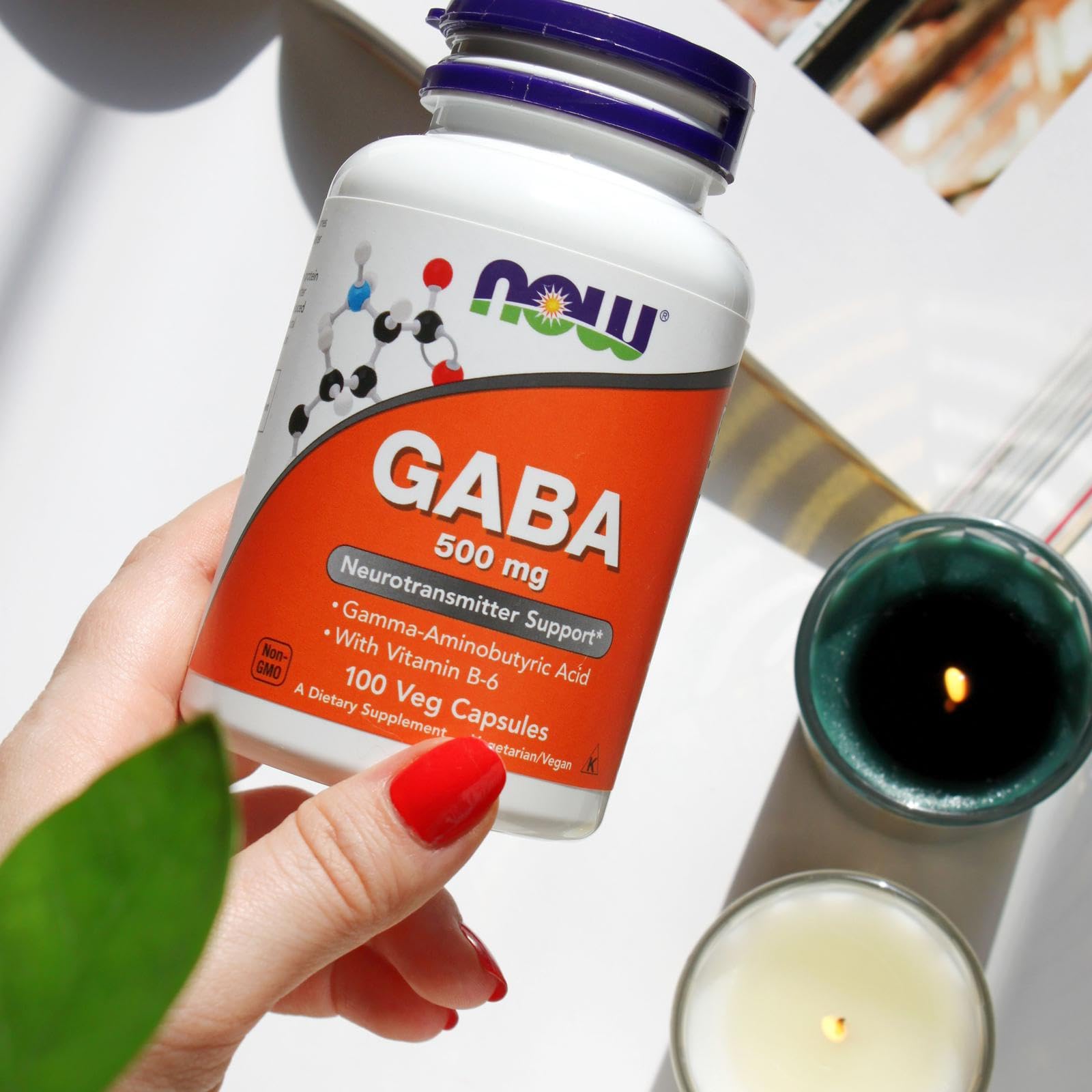 NOW Foods GABA bottle with glass of water shows easy intake.
