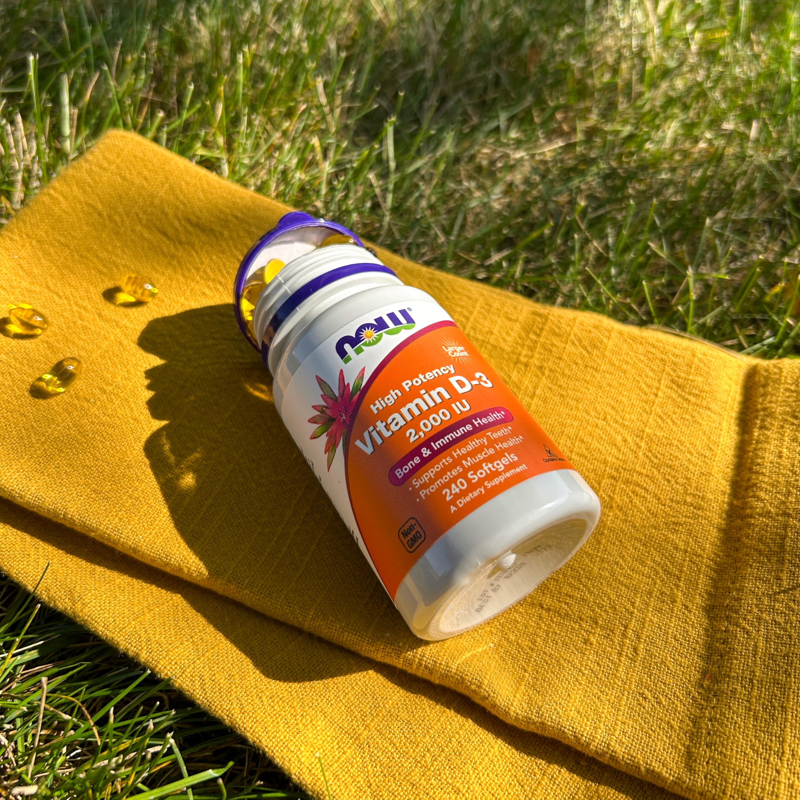 NOW Foods Vitamin D3 softgels on a kitchen counter for bone support.