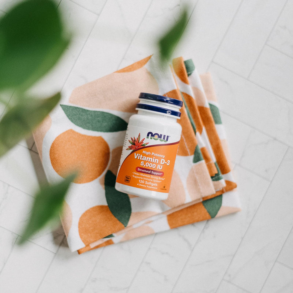 NOW Foods Vitamin D3 bottle on table ready for daily bone and immune support