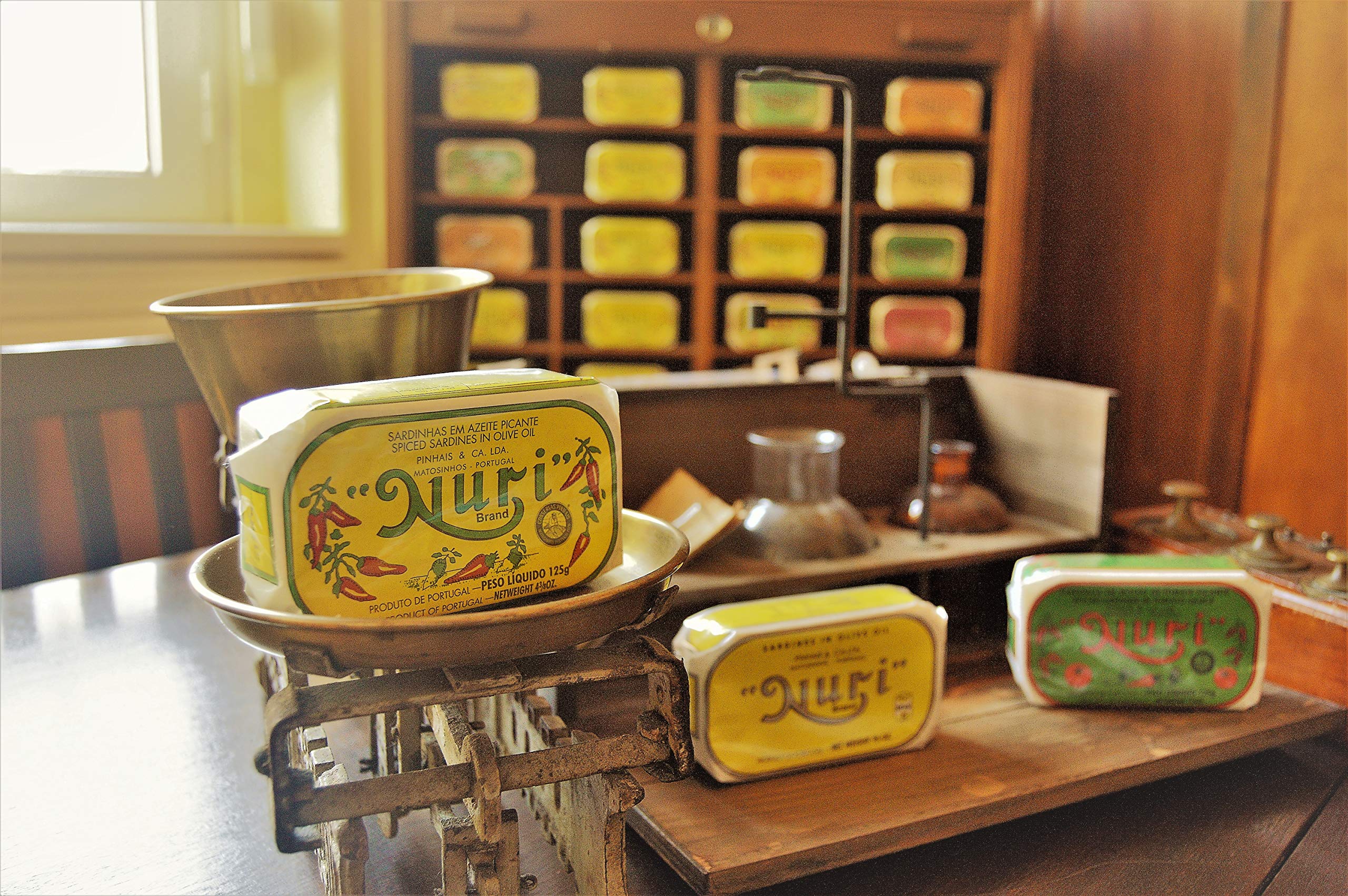 Hand-wrapped NURI cans with vintage design, ideal for gifting.